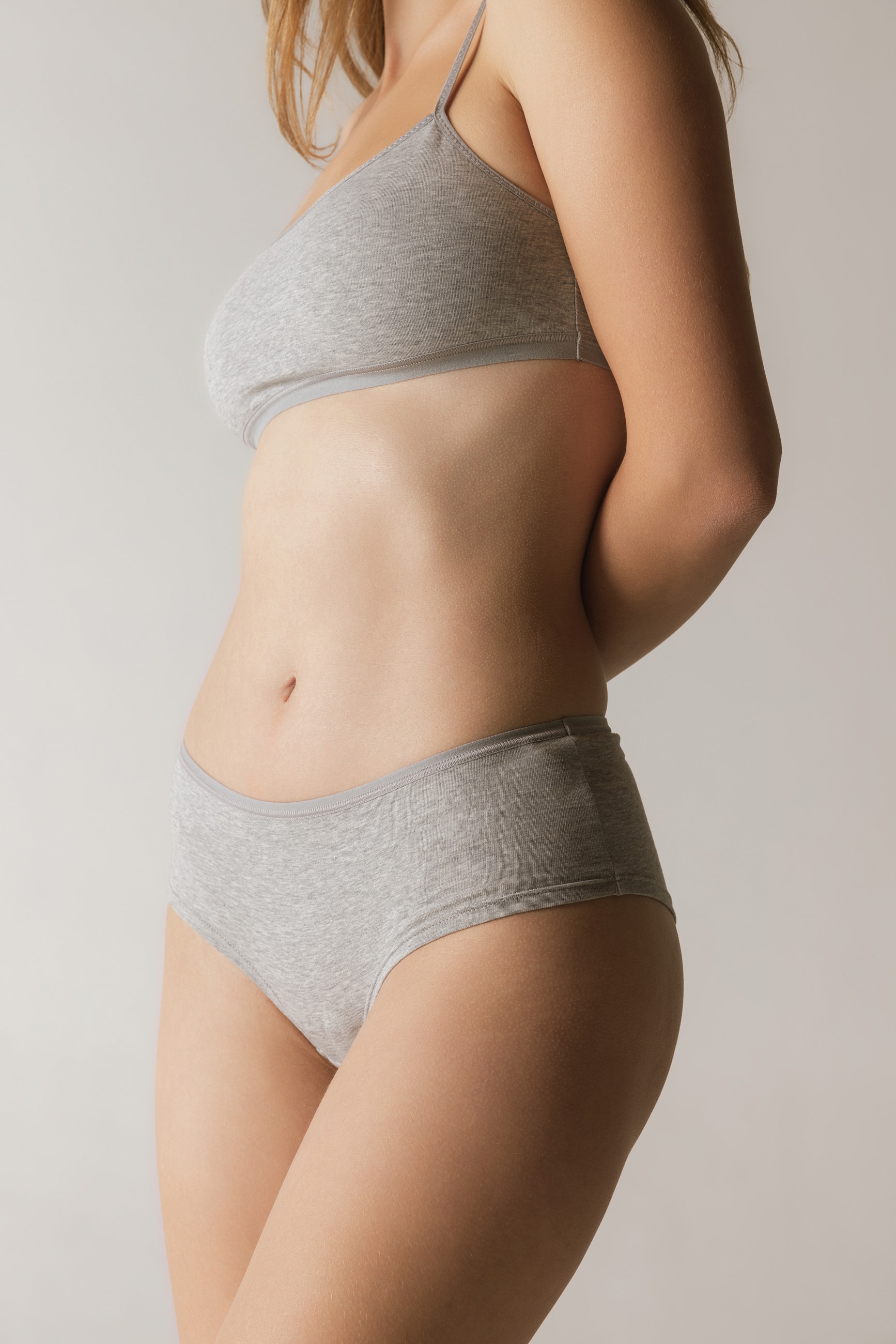 Model wearing gray casual underwear, side profile.