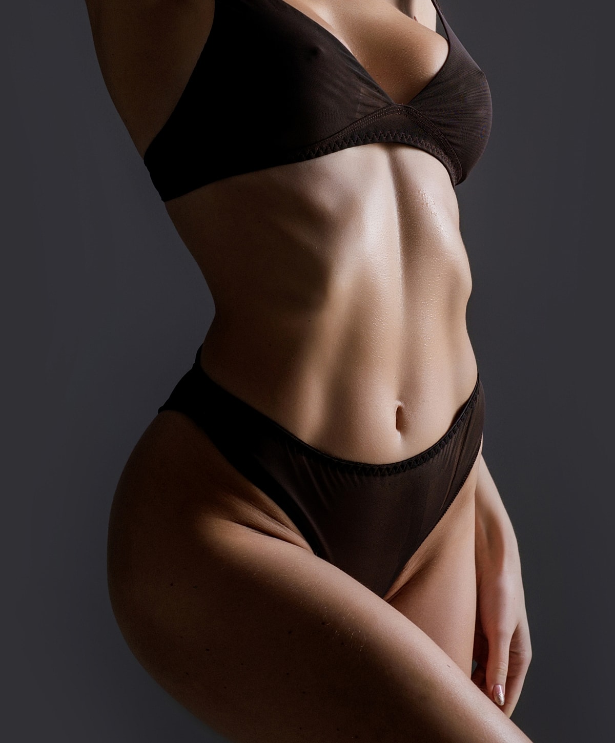 Houston body contouring model in dark lingerie posing elegantly.