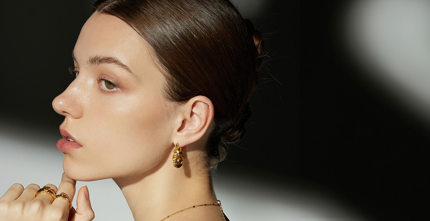 Houston plastic surgery model showcasing elegant jewelry and beauty.