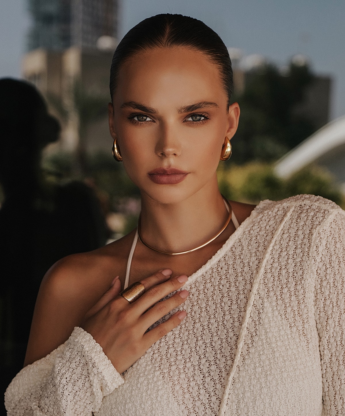 Model in elegant attire with jewelry outdoor portrait.