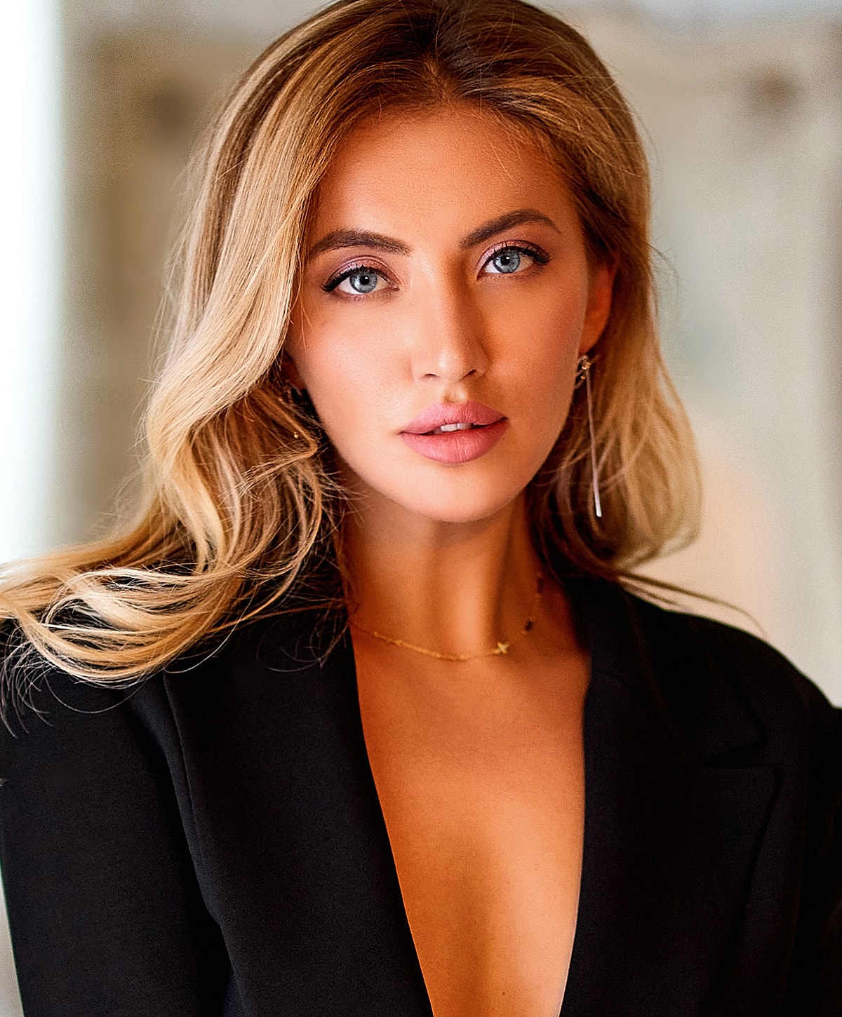 Portrait of a woman with long, wavy hair.