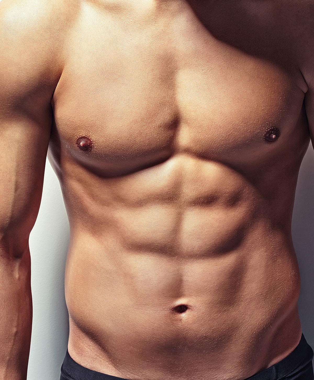 Close-up of toned male abdomen and chest.