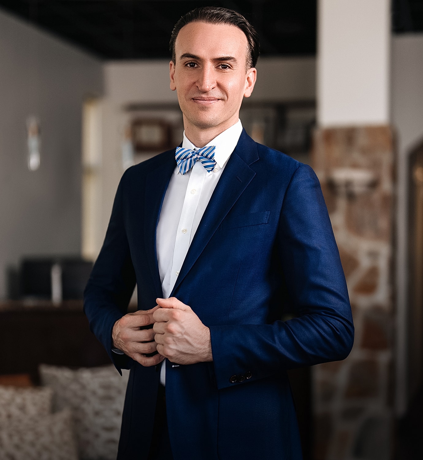 Man in a blue suit with a bow tie.